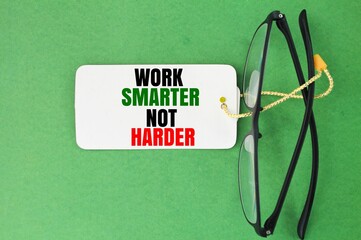glasses and a paper tag with the words Work Smarter Not Harder. the concept of working better or...
