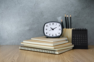 Notebook and clock and calendar on table. Work desk space