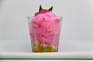 Es doger made from sugared sweet coconut milk based ice in pink syrup, served with red tapioca pearls, avocado, cassava tapai, black glutinous rice, jackfruit, diced bread and condensed milk.