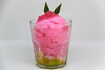 Es doger made from sugared sweet coconut milk based ice in pink syrup, served with red tapioca pearls, avocado, cassava tapai, black glutinous rice, jackfruit, diced bread and condensed milk.