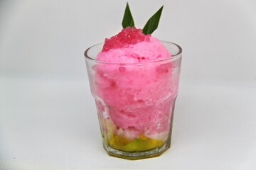 Es doger made from sugared sweet coconut milk based ice in pink syrup, served with red tapioca pearls, avocado, cassava tapai, black glutinous rice, jackfruit, diced bread and condensed milk.