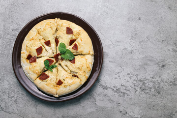 Flat Lay Of Pizza Melted Cheese Topped With Sausage On Plate Over Grey Background