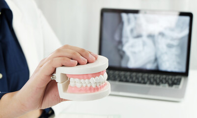 Dentist examining a patient teeth medical treatment at the dental office.	