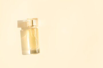 Perfume bottle on beige background, Glass bottle of perfumery