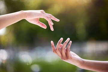 People, hands and outdoor with reaching for relationship or trust, natural with bokeh for kindness....