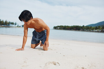 Muscular Asian Athlete Running on the Beach: A Portrait of Fitness and Freedom