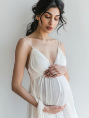 Indian pregnant woman in white dress