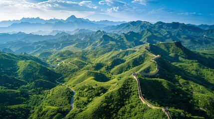 Aerial view of the Great Wall of China stretching across rugged mountains and valleys, with sections winding over steep ridges and through lush forests.     
