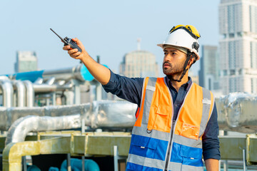 Portrait of Professional Asian man engineer in safety uniform working outdoor at construction site...