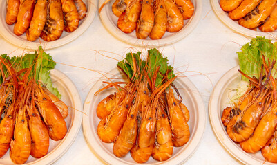 Red boiled crayfish in white plates as a background