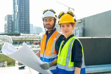 Professional Asian man and woman teamwork engineer and foreman using blueprint working outdoor at...