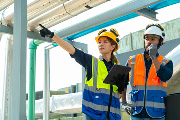 Professional Asian man and woman teamwork engineer in safety uniform working at outdoor...