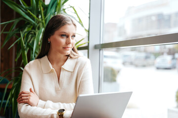 Fototapeta premium Woman Sitting in Front of Laptop Computer