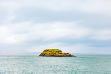 Deserted Island Surrounded by Teal Water © Cavan