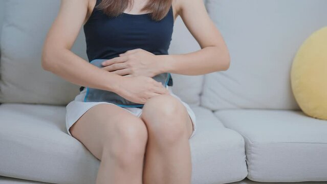 Menstruation period cycle of monthly and Stomachache concepts. woman having abdomen pain and menstrual ache with hot water bottle, illness female suffer from premenstrual ache and body Health problem