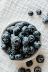 Close-up of blueberries in a bowl on textured background