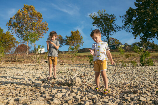 Two brothers enjoy a sunny day searching for rocks and shells