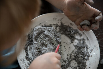 Child engaged in a hands-on fossil excavation activity