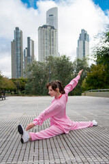Woman doing Tai chi in city landscape
