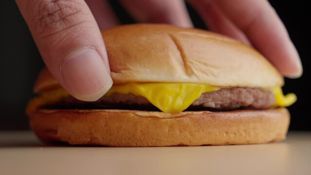 Closeup shot at mc Donald's style Cheese burger being prepared at kitchen