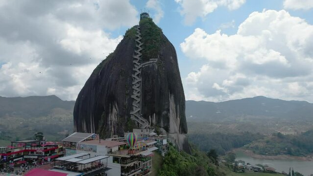 Aerial shot of El Pe&ntilde;&oacute;n de Guatap&eacute;, a large, unique rock standing alone with stairs to the top and offering panoramic views, Guatap&eacute;, Colombia_orbital shot. La Piedra del Pe&ntilde;ol Guatap&eacute; Rock.