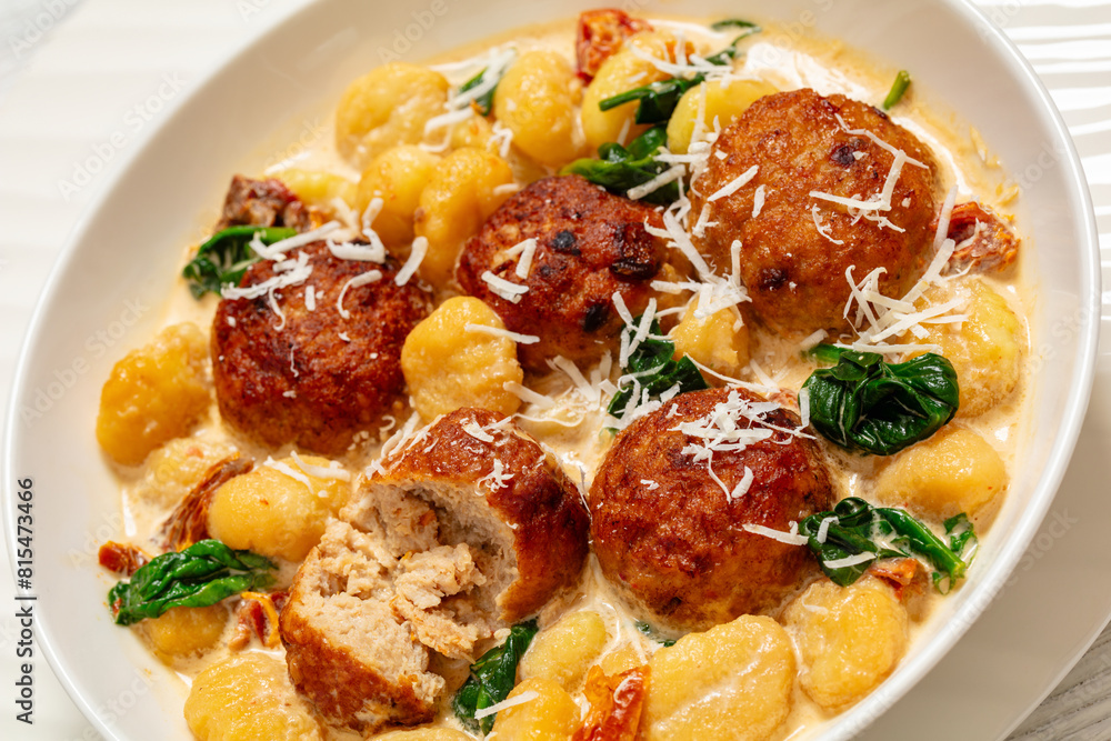 Sticker tuscan chicken meatballs with gnocchi in a bowl