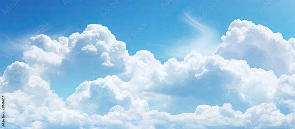 Poster Background copy space image of a sky filled with fluffy white clouds against a vibrant blue backdrop