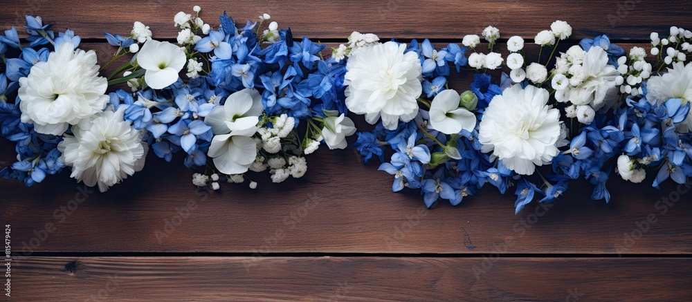 Aufkleber A visually striking arrangement of blue and white flowers on a wooden background captured from an overhead perspective with empty space for additional content