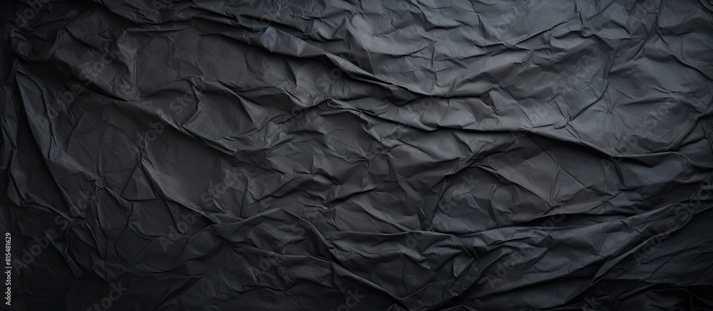 Poster A grungy textured background with a copy space image featuring crumpled and creased black paper