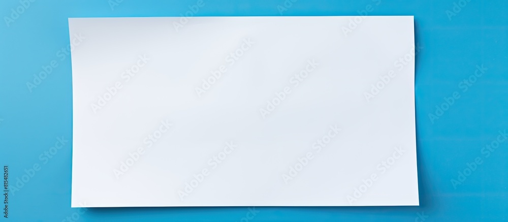 Leinwandbilder a white sheet of paper is placed on a blue background providing ample copy space for text the image 