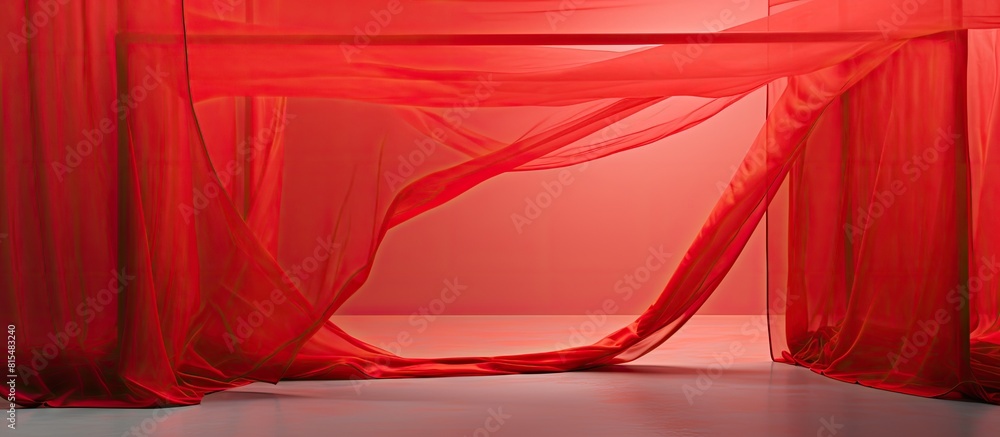 Poster a red fabric trapped in a cage like structure contrasting against a bright backdrop providing ample 