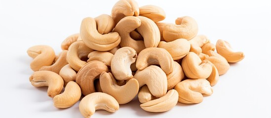 A pile of cashew nuts on a white background seen from above with empty space for additional elements