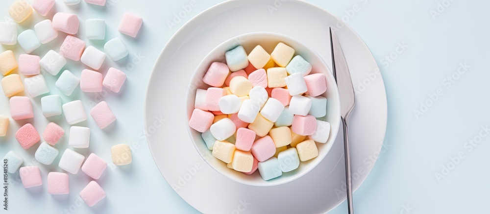 Poster a flat lay composition featuring colorful light marshmallows on a white plate with a spoon against a