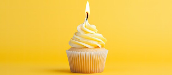 A cupcake shaped like the number 6 with a burning candle is placed on a bright yellow background providing ample space for additional images or text