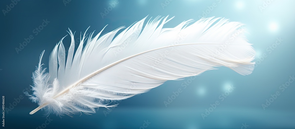 Poster A white feather floats in the air creating an abstract and ethereal ambiance There is ample copy space surrounding the feather
