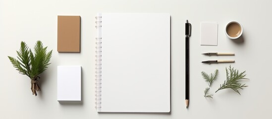 A blank stationery set is placed on a white paper background creating a template for branding identity It is ideal for graphic designers to showcase in their portfolios The image is a flat lay with a