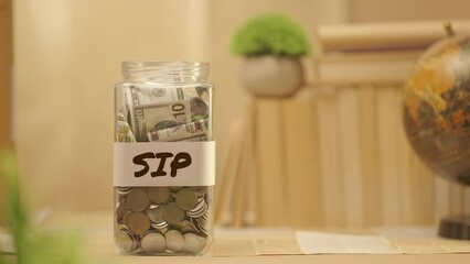 PERSON SAVING MONEY FOR SIP