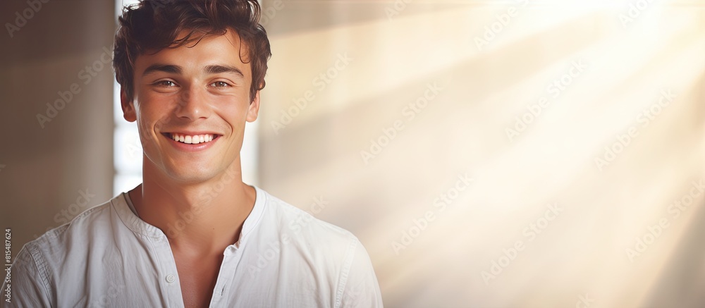 Poster Young man smiling in a portrait with a copy space background