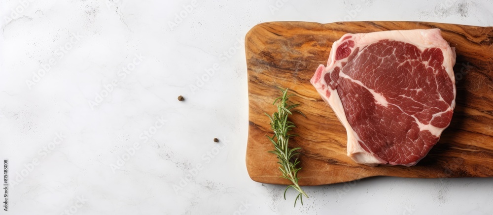 Poster A top down view of a marbled pork steak resting on a chopping board with a neutral gray backdrop providing ample space for additional imagery or text
