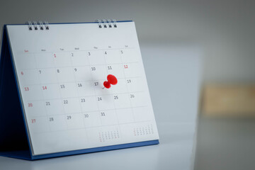 Mark on calendar white paper desk calendar with drawing-pins appointment and business meeting concept