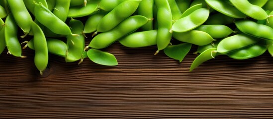 Top view of fresh soybeans also known as edamame green beans on a wooden background This copy space image showcases the vibrant and natural beauty of the beans