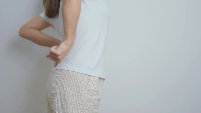 woman having back body ache during at home. adult female with muscle pain due to Piriformis Syndrome, Low Back Pain and Spinal Compression. Office syndrome and medical concept