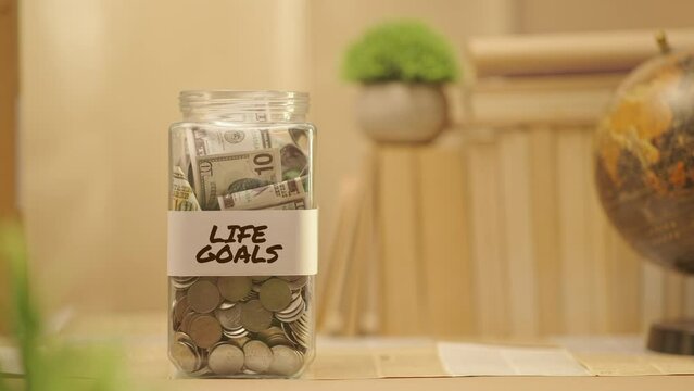 PERSON SAVING MONEY FOR LIFE GOALS