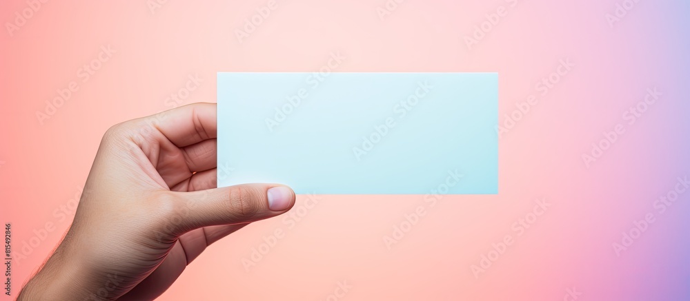 Aufkleber A hand holds a blank card with a pastel background providing a space for copying images. Creative banner. Copyspace image