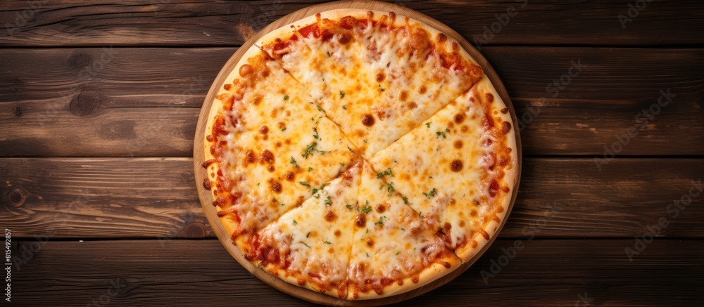 Aufkleber A homemade pizza topped with cheese is placed on a wooden table creating a flat lay view The image provides copy space
