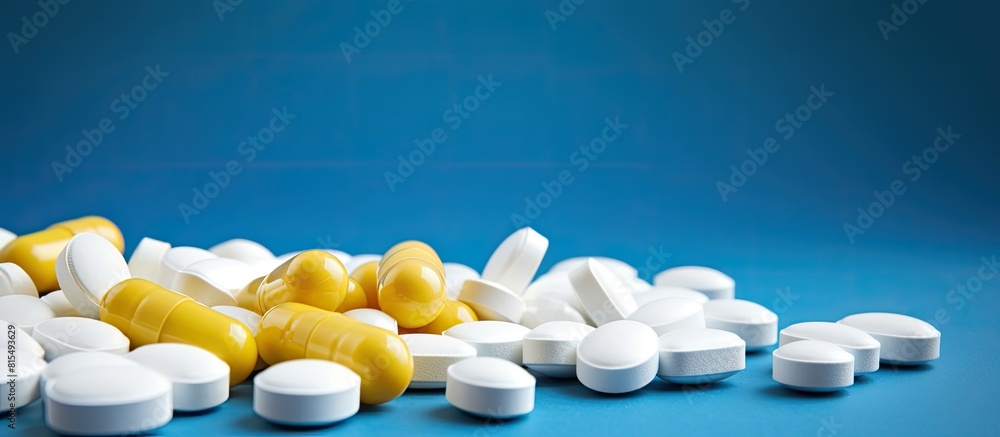 Poster a variety of white and yellow pills in different shapes and sizes are arranged on a blue background 
