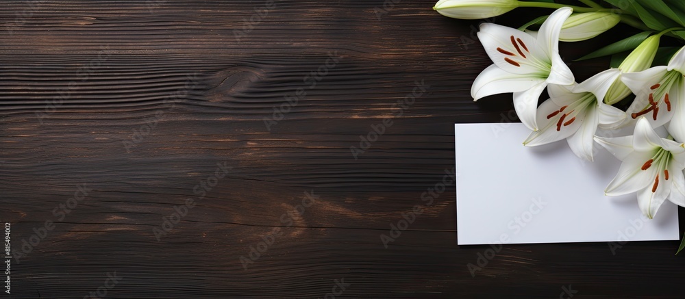 Poster a copy space image of a white greeting card and craft envelope adorned with lilies flowers placed on
