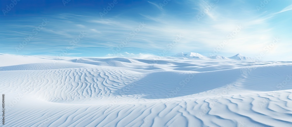 Poster winter landscape with snowy ground and wind sculpted patterns on the snow surface creating a wide pa