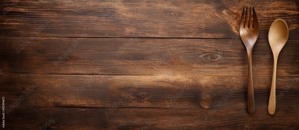 Poster A rustic wooden table with a pair of artisanal wooden spoon and fork on top leaving empty space for an image. Creative banner. Copyspace image