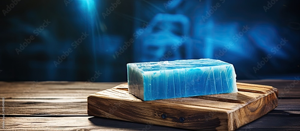 Poster Handcrafted soap displayed on a rustic blue wooden table creating a visually appealing copy space image